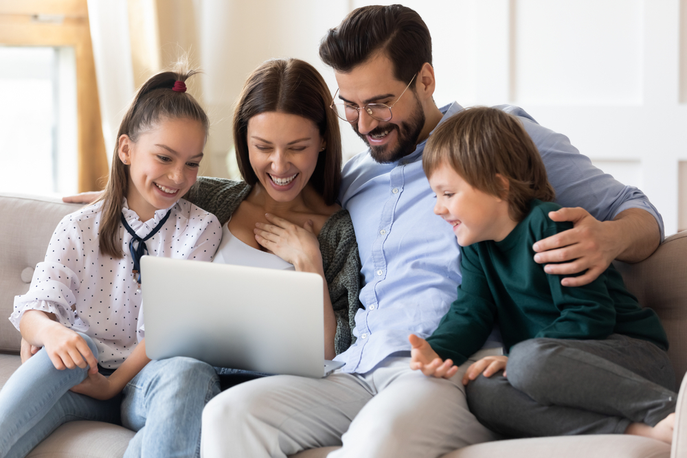 Family watching video on laptop